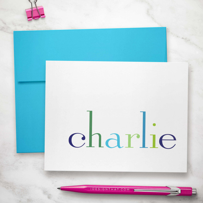 Rainbow folded notecard showing rainbow-colored name with a turquoise envelope.