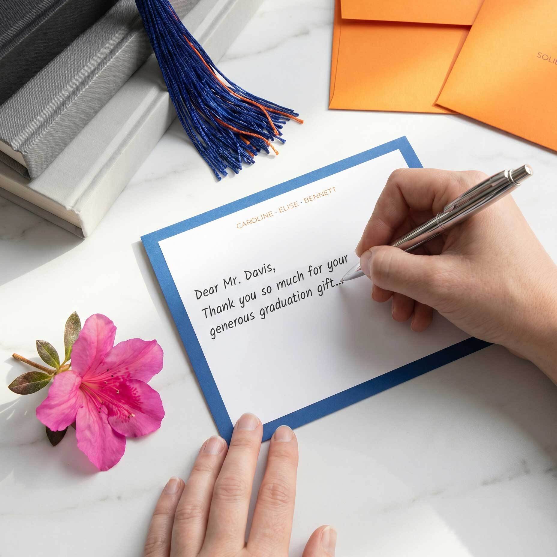 Graduation thank-you note writing scene with personalized stationery for sending handwritten notes after milestone gifts