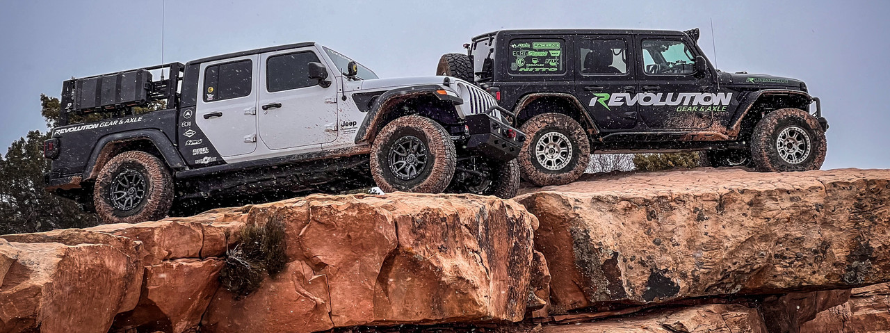 Two Revolution Gear & Axle Jeeps on a slickrock ledge in Moab, Utah