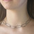Modern Art Jewelry on model from Morgan Amirani | Argentium Silver Lets Connect Choker with 18 Karat Gold and Ruby accents. Modern Art Jewelry on model from Morgan Amirani | Argentium Silver Lets Connect Choker with 18 Karat Gold and Ruby accents.
