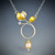 Contemporary Jewelry, Sapphire Circle Pendant from Judith Neugebauer | Sterling Silver and 23 Karat Gold Leaf | White Sapphire Contemporary Jewelry, Sapphire Circle Pendant from Judith Neugebauer | Sterling Silver and 23 Karat Gold Leaf | White Sapphire