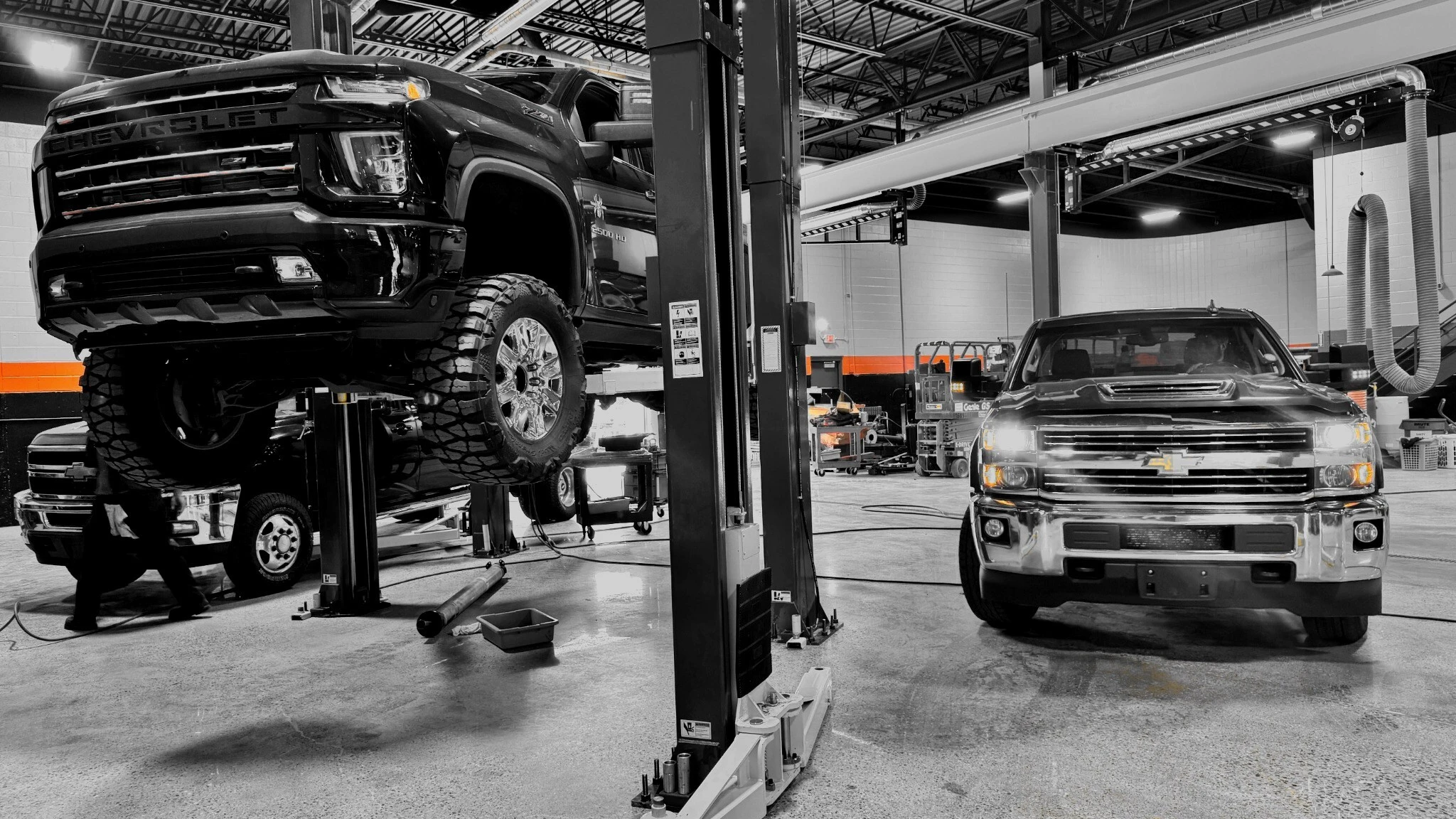 Duramax diesel trucks being serviced inside Merchant Automotive's Holland shop