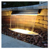 Copper finish spillway with warm LED lighting in stone wall. Copper finish spillway with warm LED lighting in stone wall.