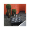 Modern garden installation with OASE Water Trio fountain feature among decorative planters.