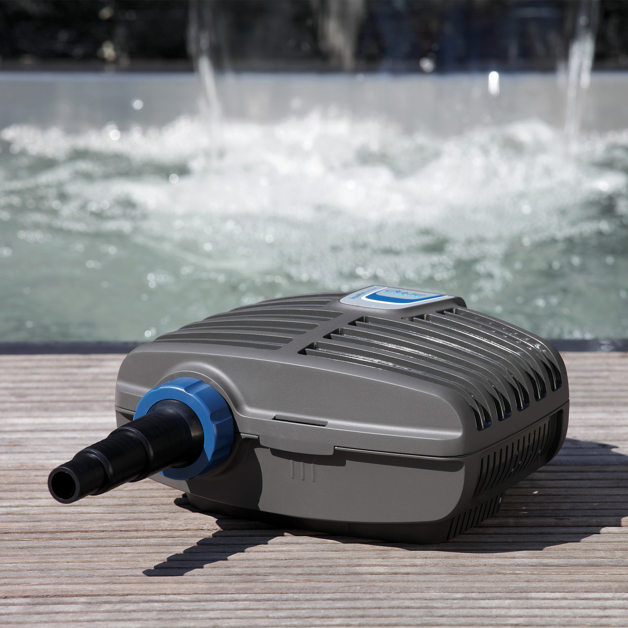 Oase pond filter pump with black vented housing and blue hose connector for water circulation.