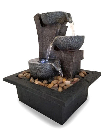 Side-angle view of a meditation fountain with a tiered design, allowing water to flow from one level to the next. Side-angle view of a meditation fountain with a tiered design, allowing water to flow from one level to the next.