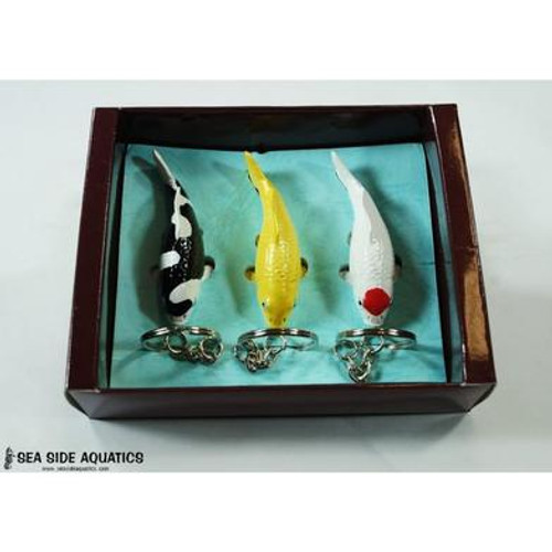 Set of three miniature koi fish keychains displayed in a presentation box, featuring black-and-white Shiro, golden Ogon, and white Tancho with a red spot.