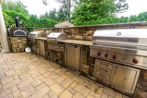 The Perfect Backyard Upgrade: Outdoor Kitchen & Bar Complementing the Pond