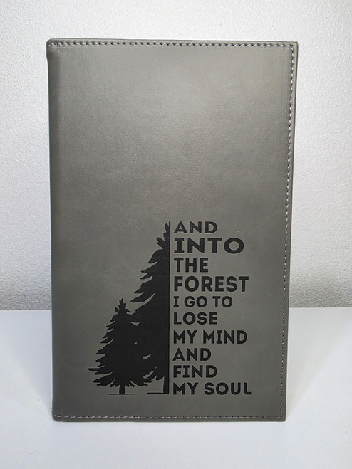 into the forest engraving at bottom on gray notebook journal
