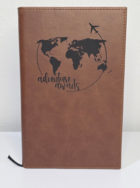 adventure awaits world map design engraving on brown notebook journal
