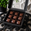Open gift box of nine handcrafted Espresso Martini bonbons in a premium black box, artisan cocktail-inspired chocolates by Bomb Confections.