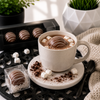 Classic milk chocolate hot cocoa bomb with white chocolate drizzle melting into a warm mug of hot chocolate, styled with mini marshmallows, chocolate curls, and individually boxed cocoa bombs in Bomb Confections' signature luxury presentation.