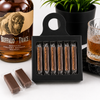 Six pieces of Buffalo Trace bourbon pecan toffee in a black bottle hanger gift box
