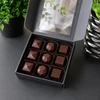 Open gift box featuring the Bomb Confections Espresso Bonbon Collection with Espresso, Baileys & Coffee, and Espresso Martini artisan chocolates arranged in a premium assortment.