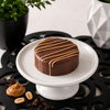 Peanut butter chocolate covered sandwich cookies with peanut butter drizzle, individually boxed and packaged in a clear two-cookie gift box by Bomb Confections.