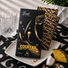 Bomb Confections Piña Colada Rum Chocolate Bar in premium cocktail-inspired gift packaging with handcrafted pineapple and toasted coconut chocolate bars displayed behind the package, styled with tropical pineapple and coconut accents.