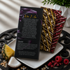 Back of Bomb Confections Piña Colada and Raspberry Daiquiri rum chocolate bar gift package displayed with both artisan chocolate bars and tropical pineapple, coconut, and raspberry accents.