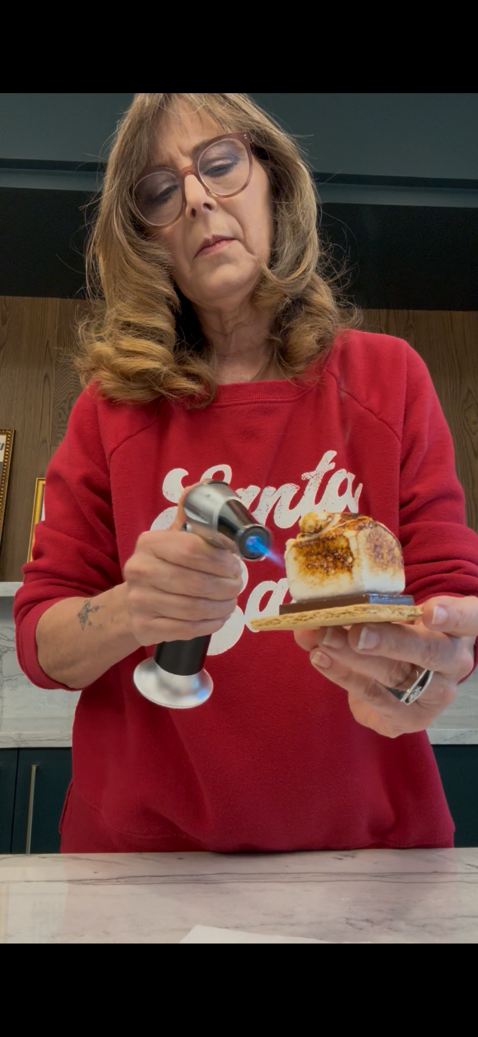 Sandi torching a bourbon s'more at a Bomb Confections event