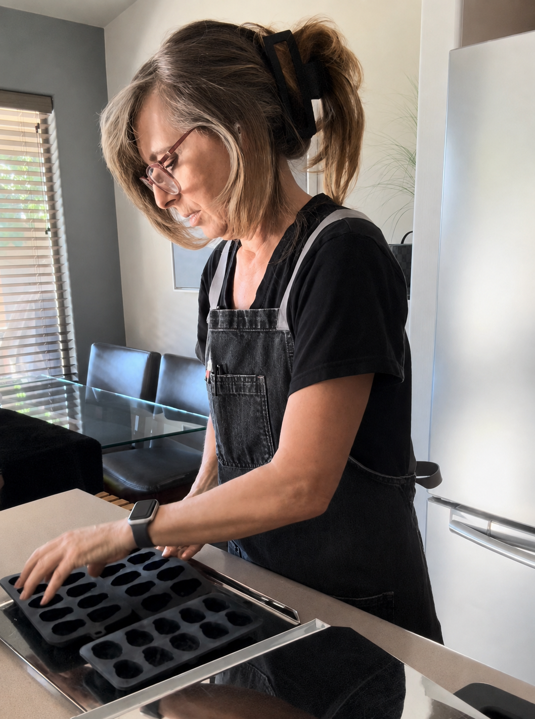 Sandi of Bomb Confections working with chocolate molds in her kitchen