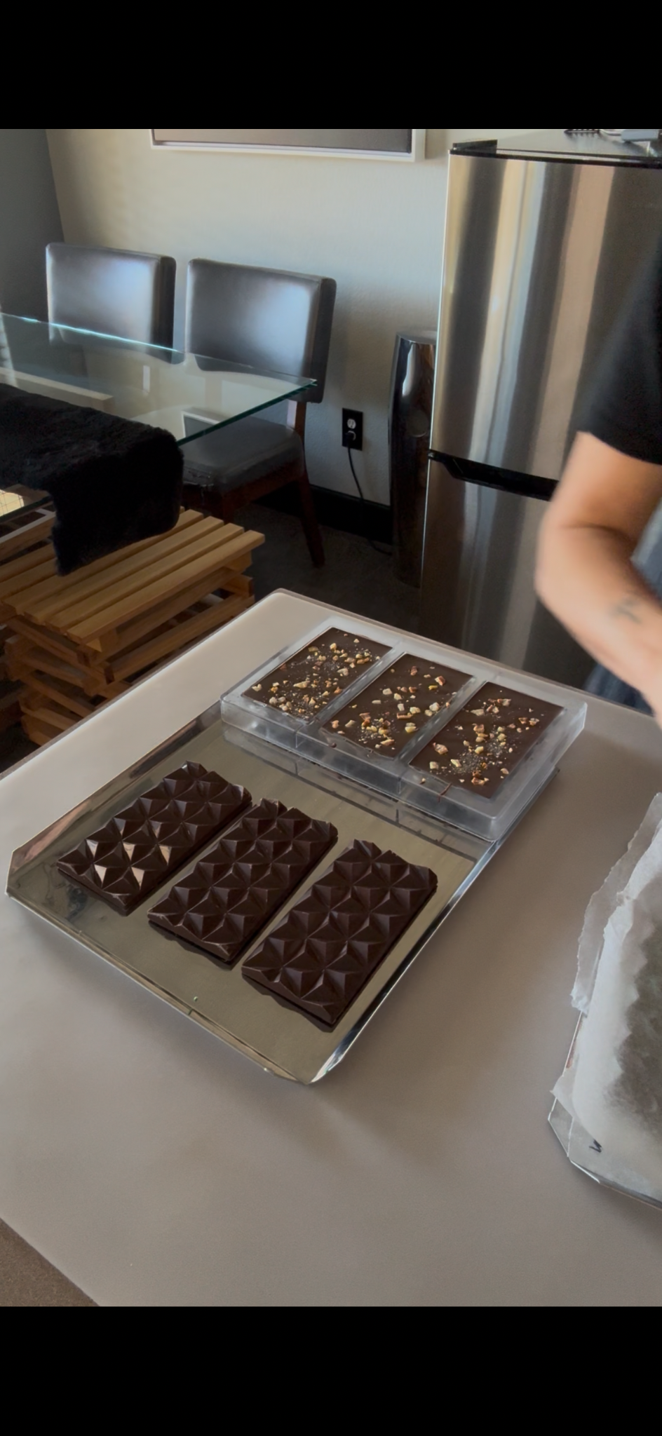 Sandi unmolding handcrafted chocolate bars in the Bomb Confections kitchen