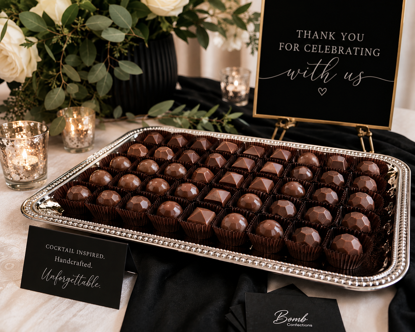 Cocktail-inspired Bomb Confections bonbons displayed on an elegant wedding dessert table