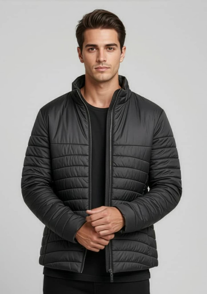 A puffer jacket in black, featuring a zip-up front and a modern, fitted design, with a logo on the chest.
