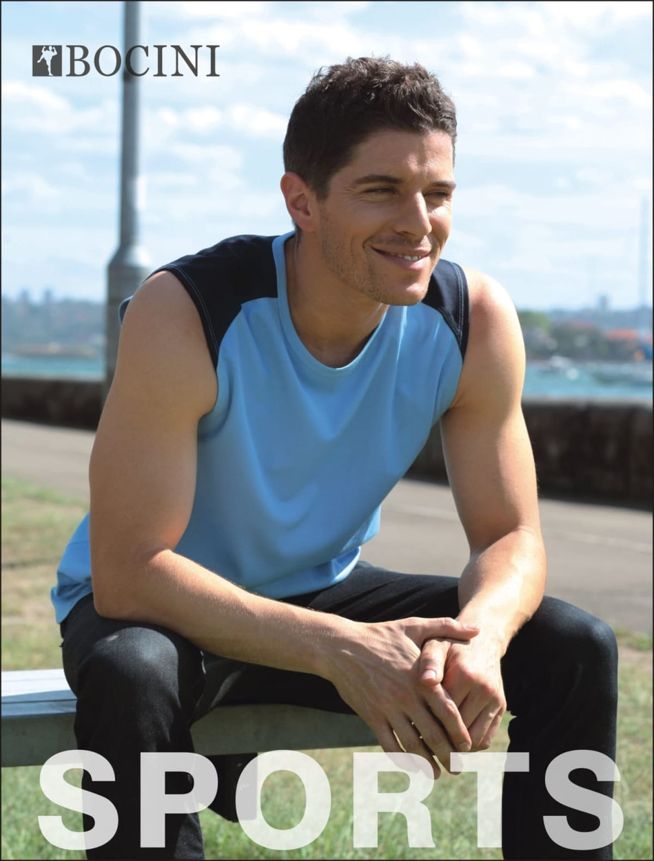 A men's contrast feature tank in light blue with black accents, displayed by a model outdoors. The tank has a logo.
