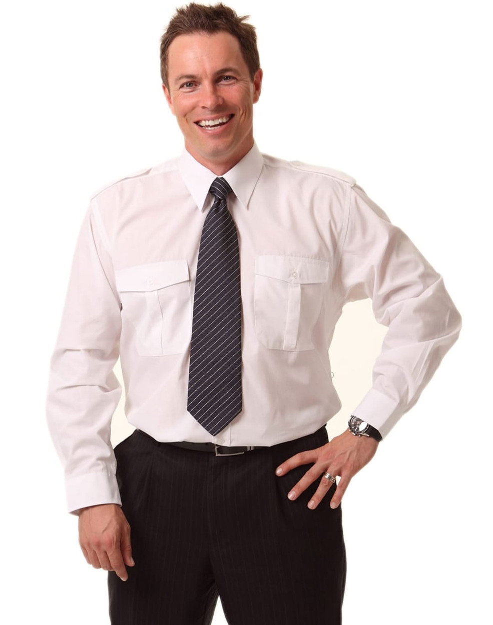 A man wearing a white long sleeve button-up shirt with epaulettes and a striped tie, posing confidently.