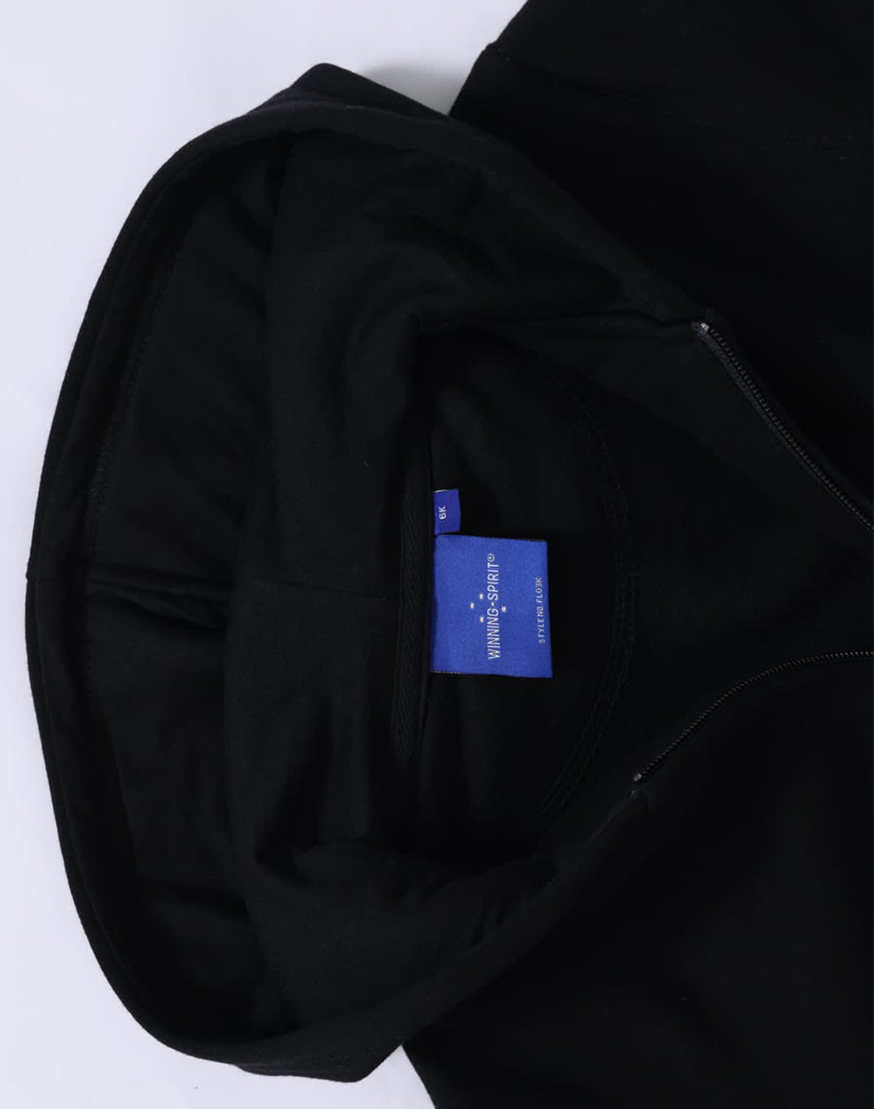 A black full-zip fleecy hoodie with a hood and a label inside.