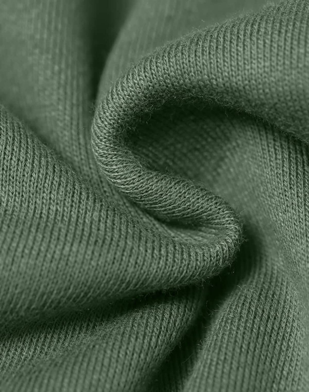 A close-up of textured fabric in a muted green colour, highlighting its soft and snug qualities.