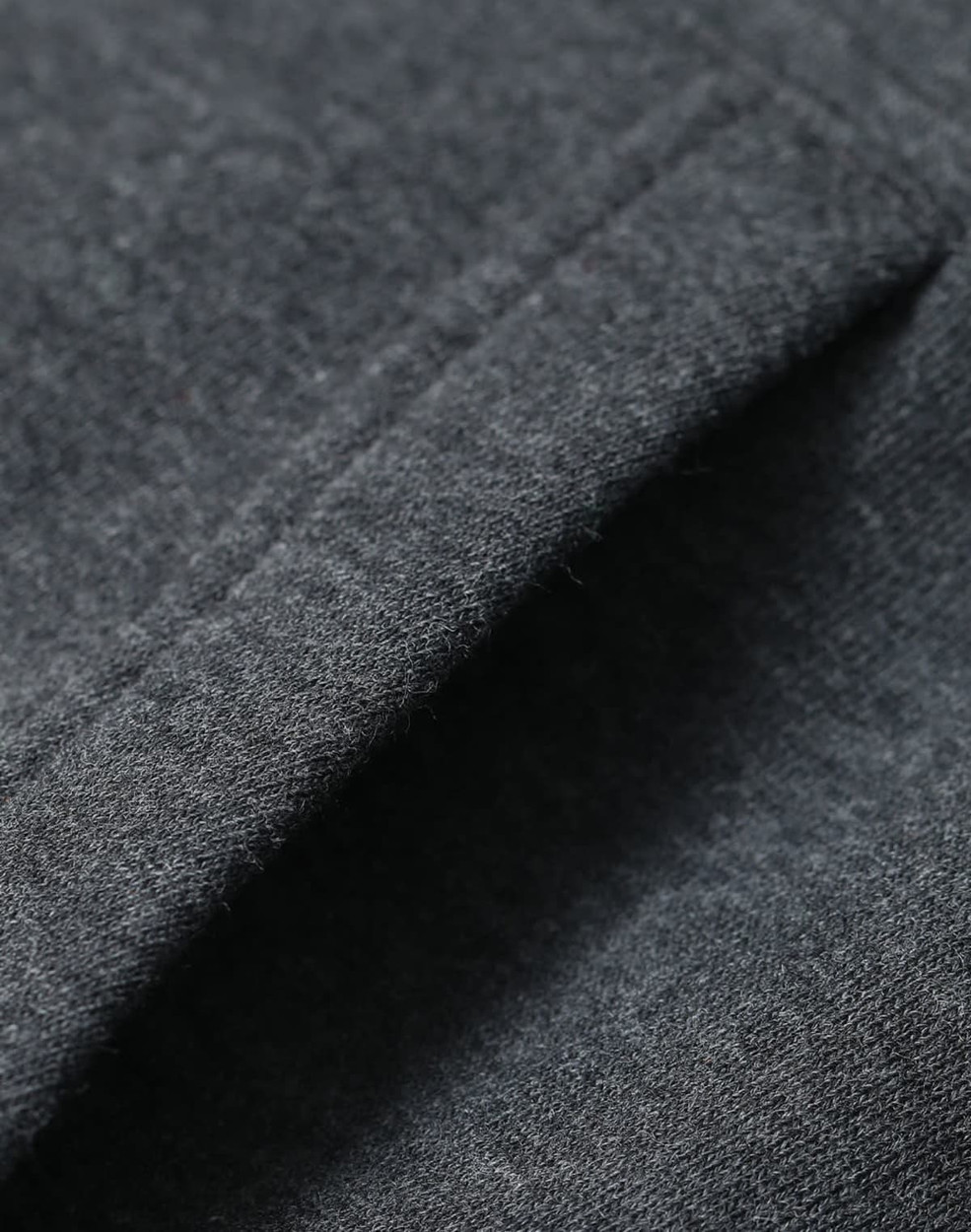 A close-up of a fleecy fabric in dark grey, showcasing the texture of the adult's contrast front hoodie.