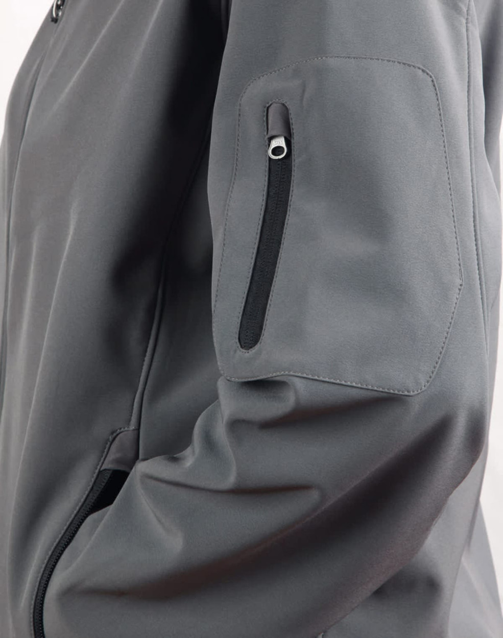 A grey Men's Softshell High-Tech Jacket featuring a zippered pocket on the sleeve and a sleek design.