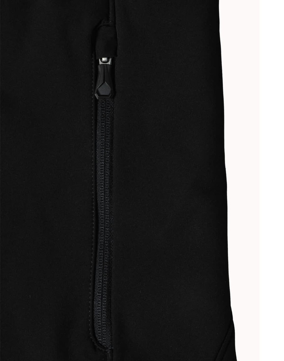 A close-up of a black softshell jacket featuring a zipped pocket and a branded logo.