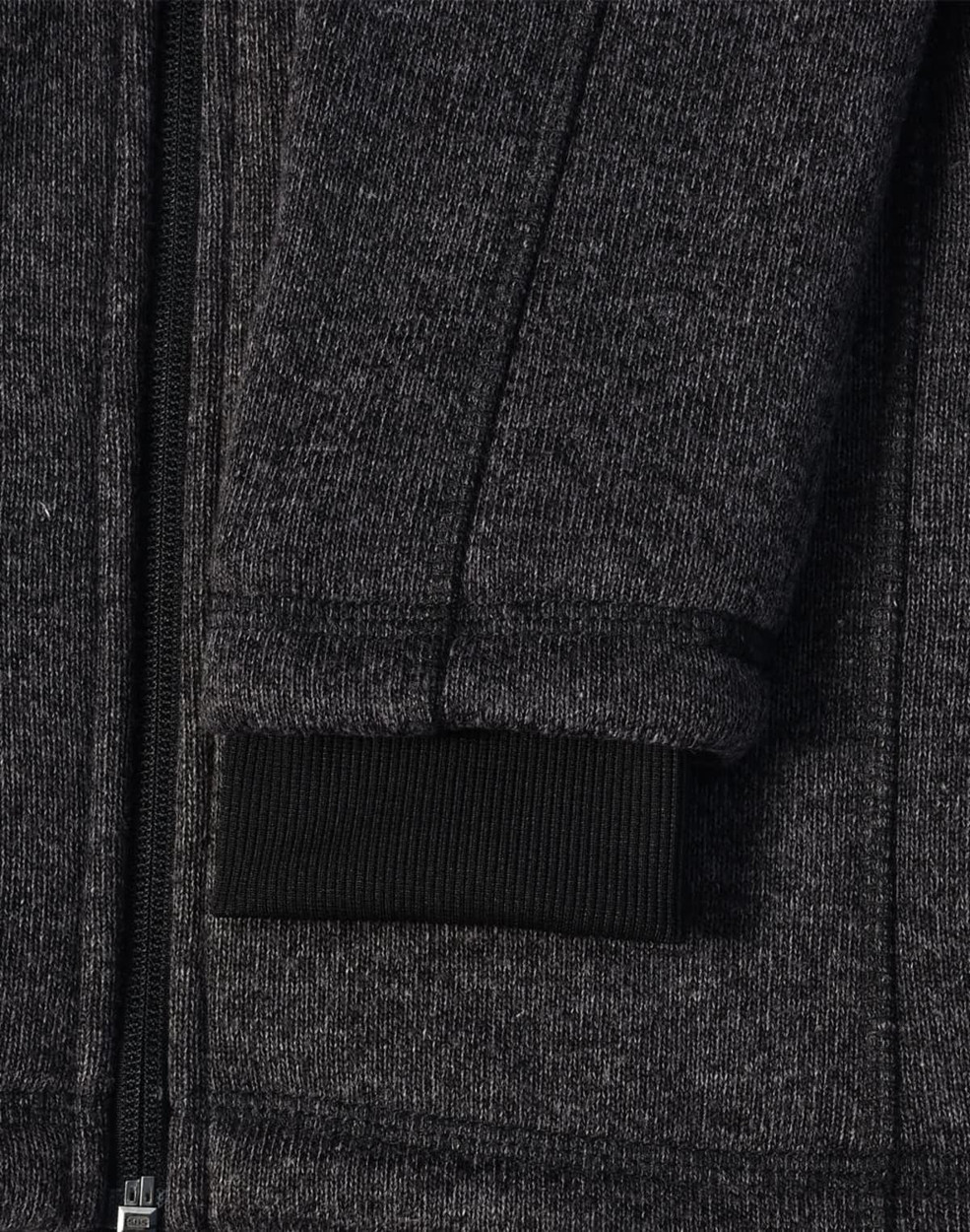 A dark heather grey fleece jacket with a black ribbed cuff and zipper detail. It also features a logo.