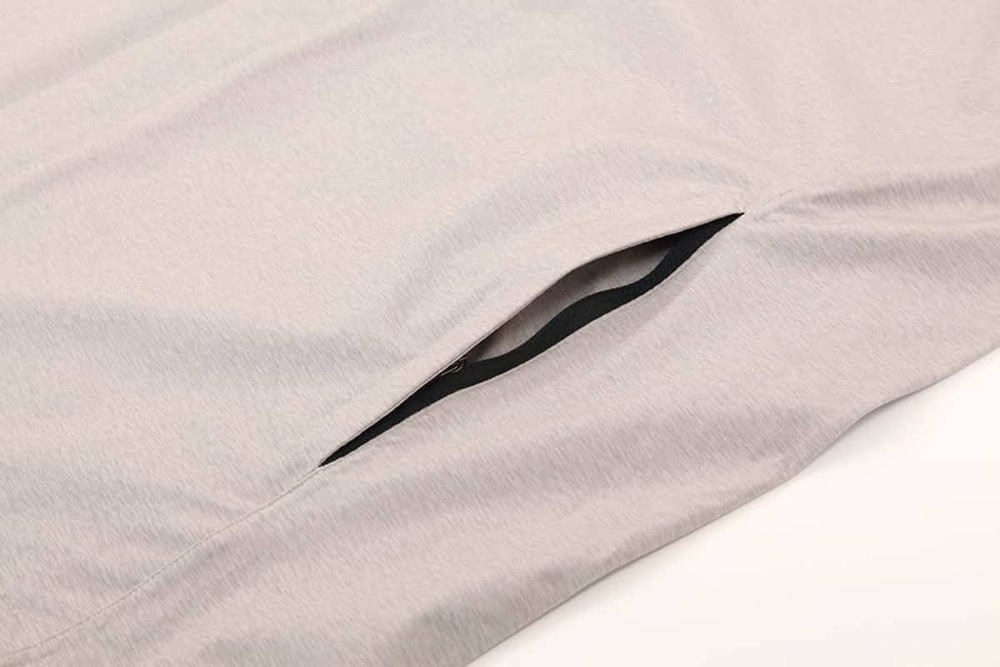 A light grey performance jacket featuring a zipped pocket on the side, designed for waterproof protection.