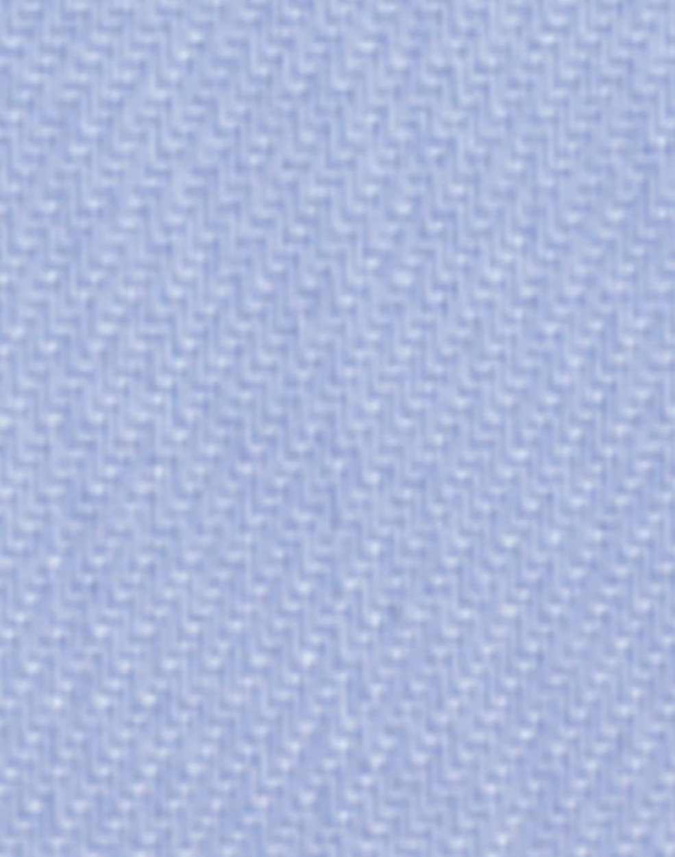 A close-up of light blue fine twill fabric, featuring a textured woven pattern, suitable for button-up shirts.