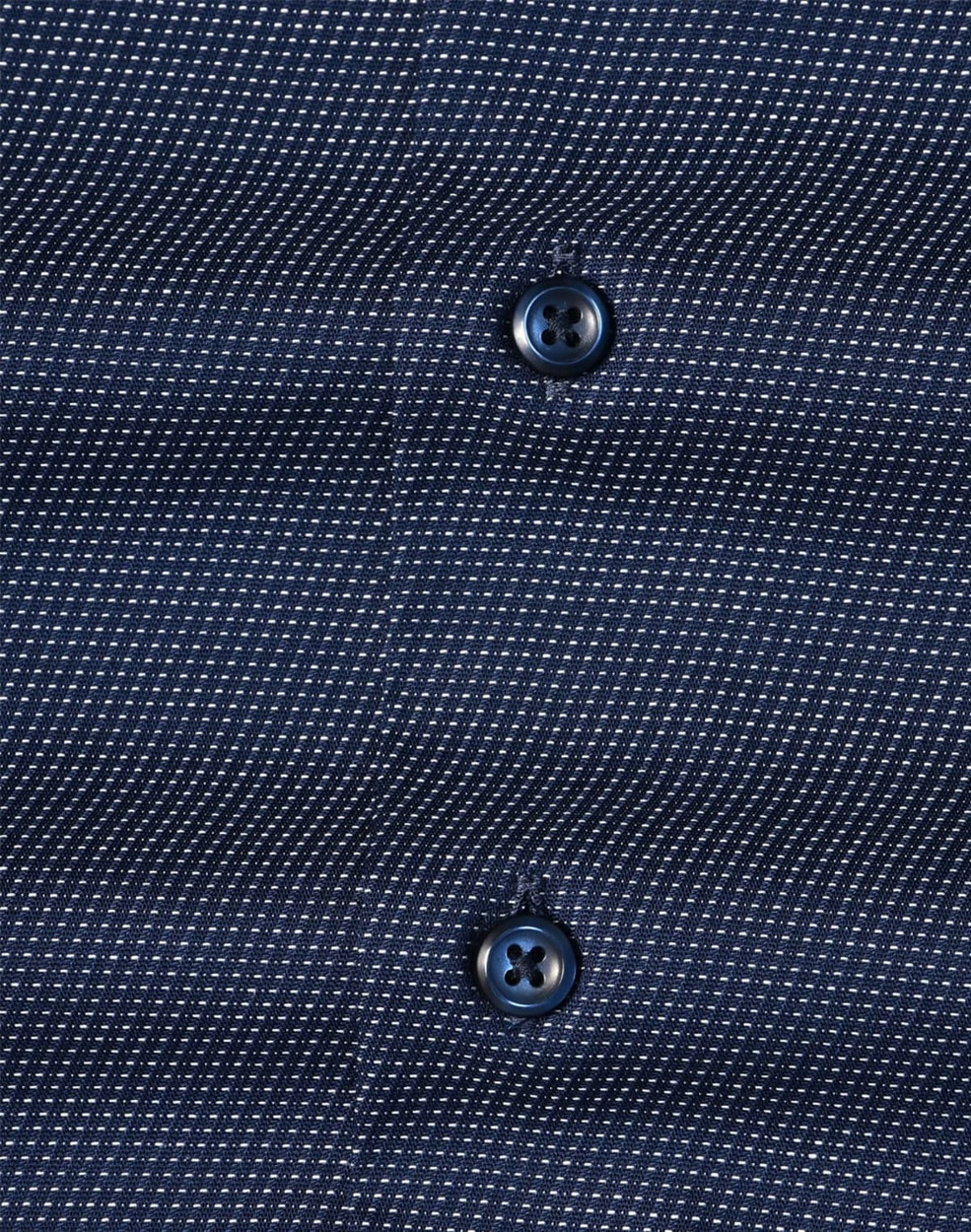 Men's long-sleeve button-up shirt in navy with a pin dot pattern and two dark buttons. Features subtle texture.