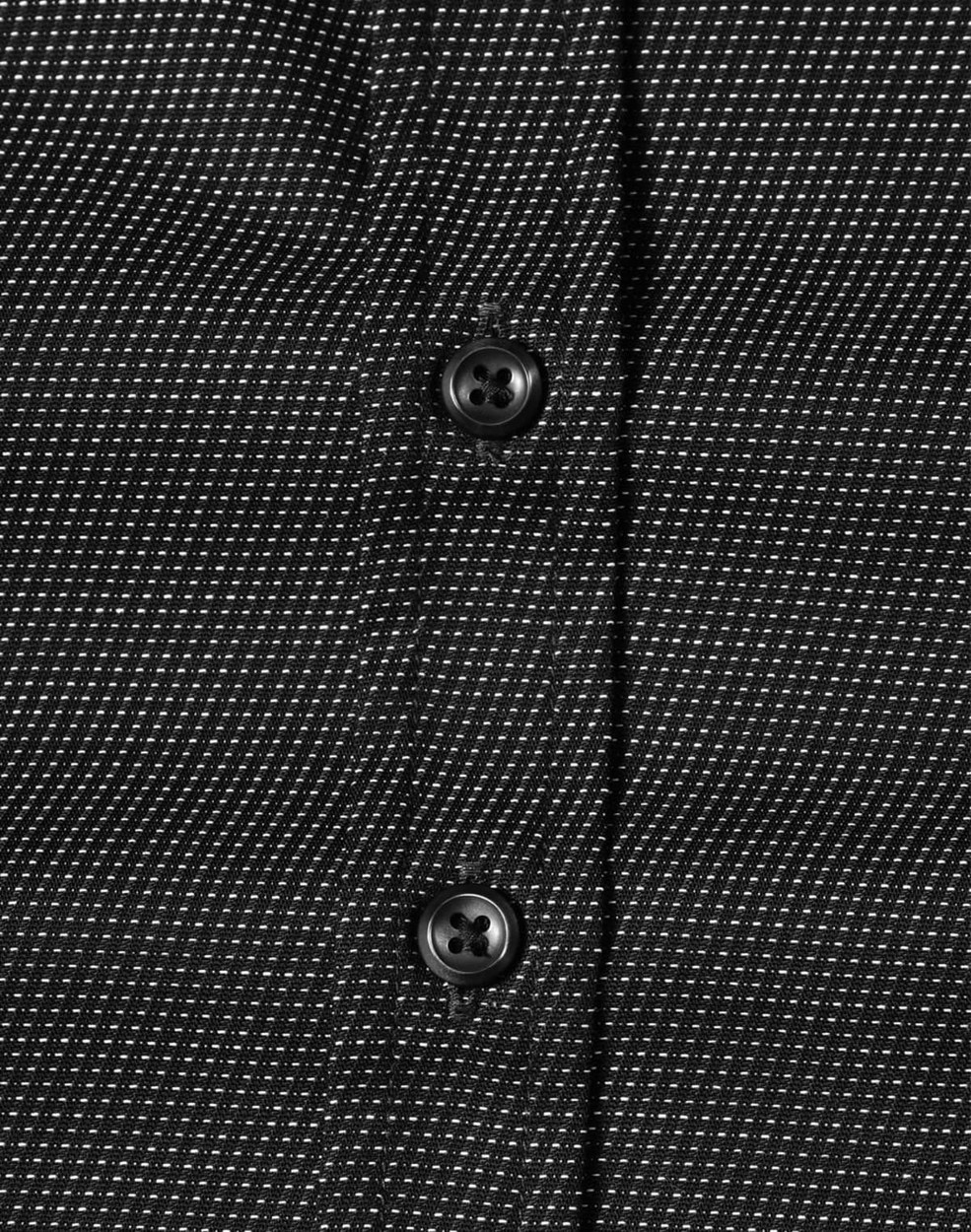 A black and white pin dot button-up shirt featuring a close-up view of buttons.