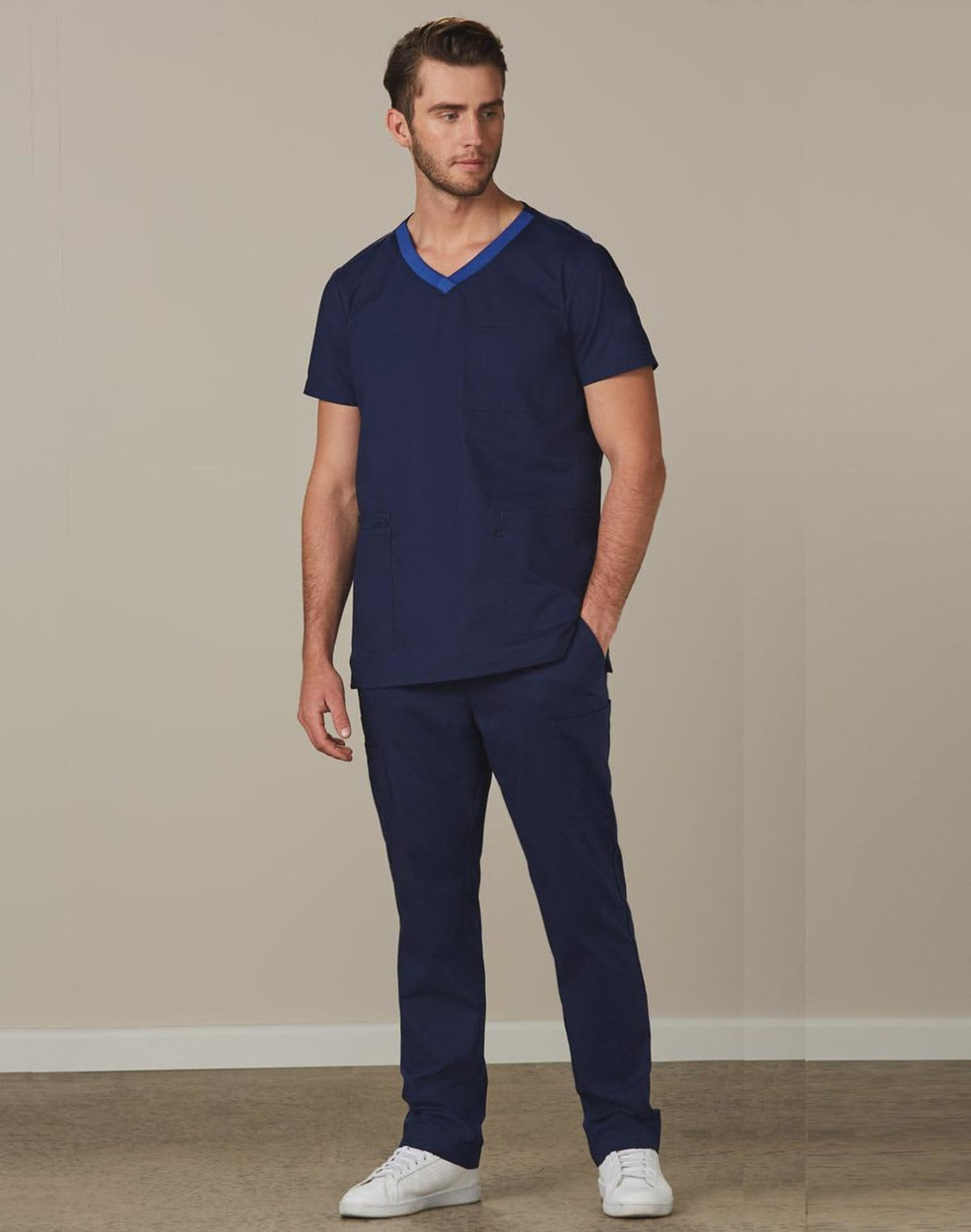 Men's solid navy scrub pants paired with a matching navy scrub top, featuring a logo on the garment.