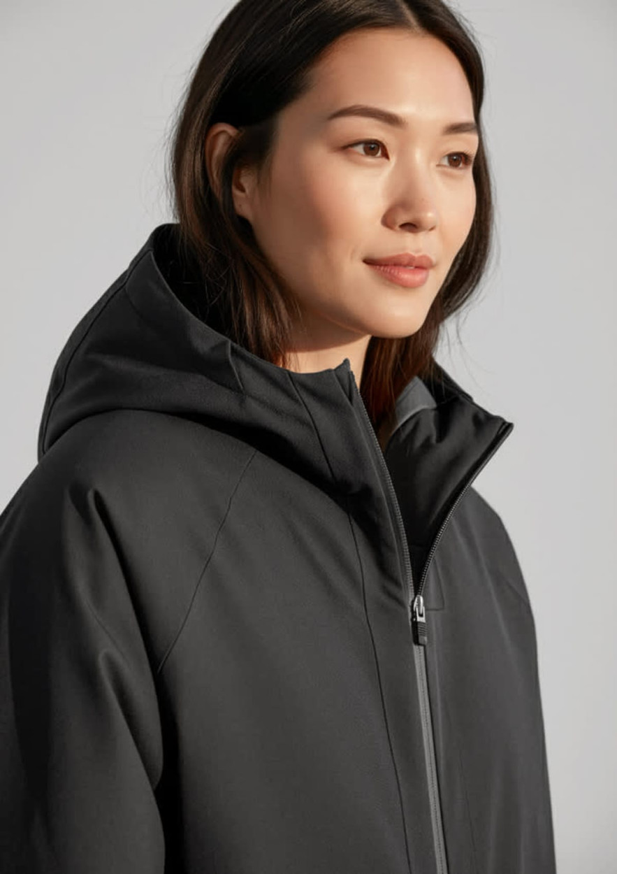 A unisex black sphere jacket with a hood, featuring a zip and a branded logo.