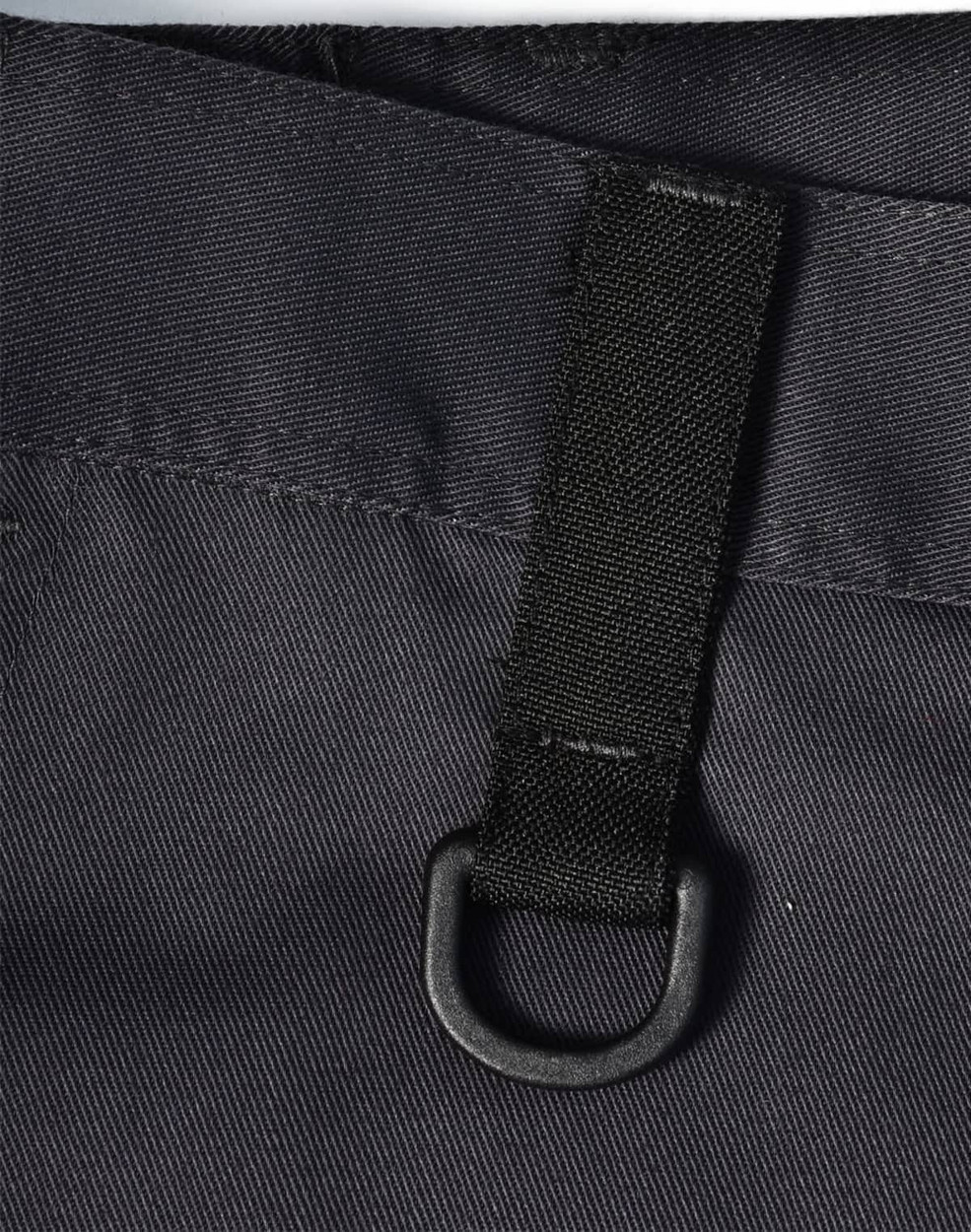 A close-up of black unisex utility stretch cargo work pants featuring a loop and sturdy fabric texture.