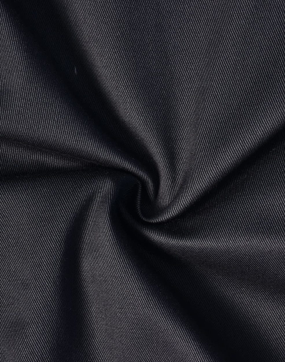 A close-up of black fabric, featuring a smooth, durable texture suitable for cargo pants.