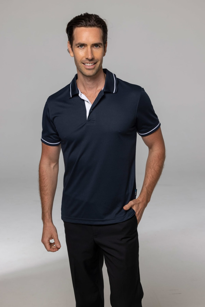 A navy polo shirt with white collar detailing, modelled by a man. The shirt features a logo.