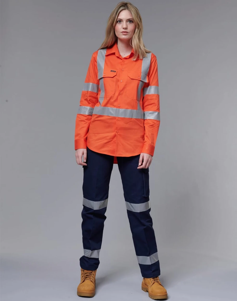 A high-visibility orange work shirt with reflective stripes, paired with dark navy pants and work boots.