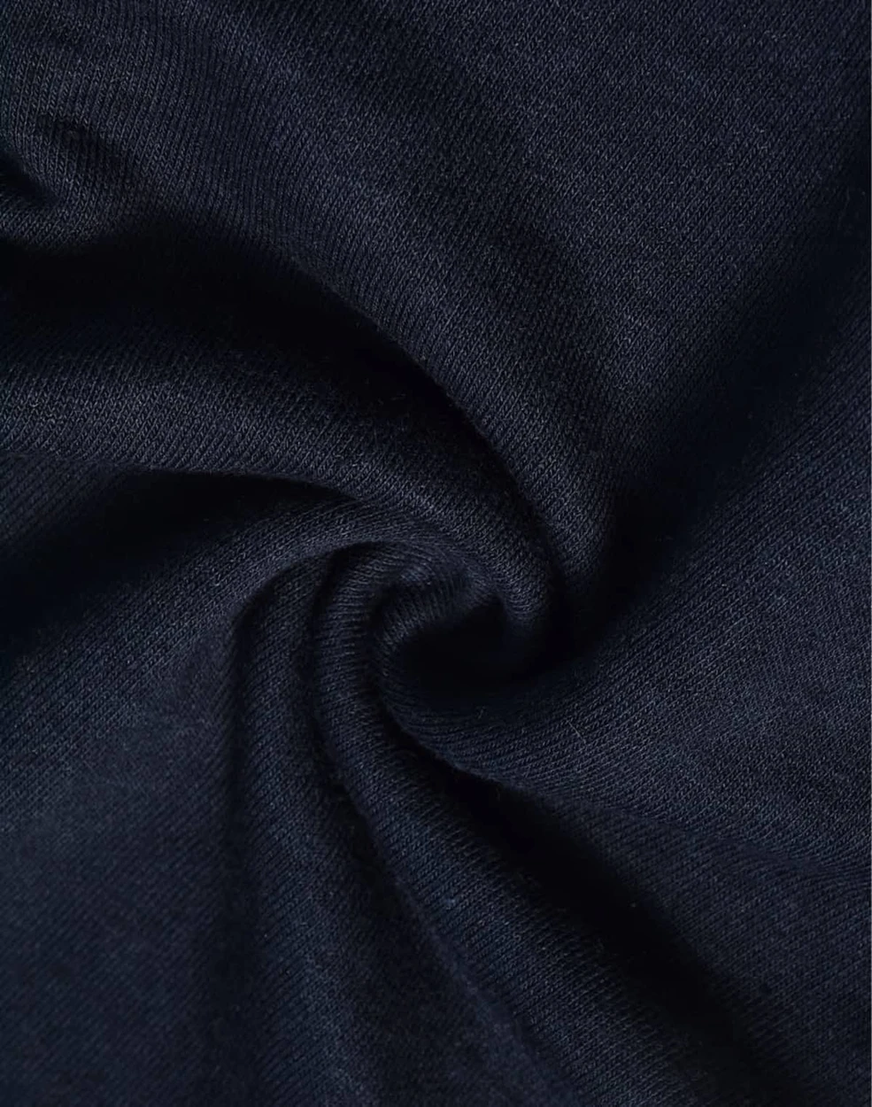 A close-up of navy blue poly/cotton terry fabric, showcasing its soft and stretchy texture. Features a logo.