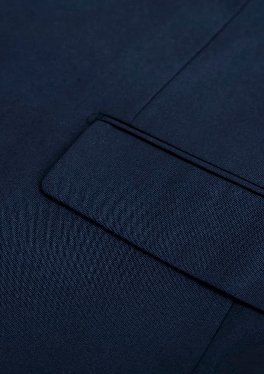 A navy blue men's jacket with a smooth texture and a detailed lapel. Features a branding logo.