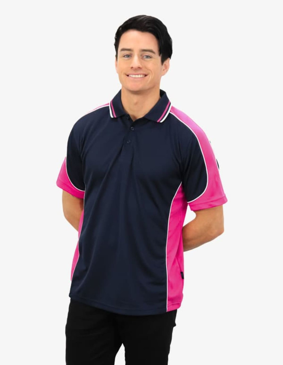 A navy and pink polo shirt featuring a logo, modelled by a smiling man.