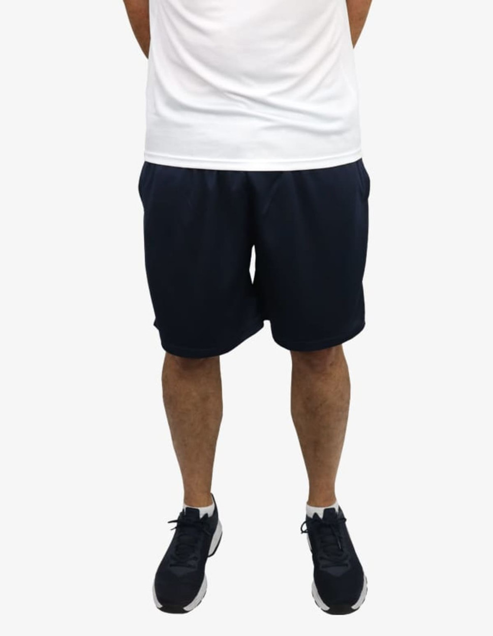 Navy blue sports shorts with an elastic waistband and side pockets, worn with a plain white shirt and black shoes.