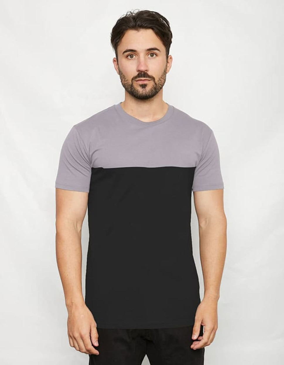 A two-toned t-shirt featuring a grey upper half and a black lower half, displayed on a model against a neutral background.