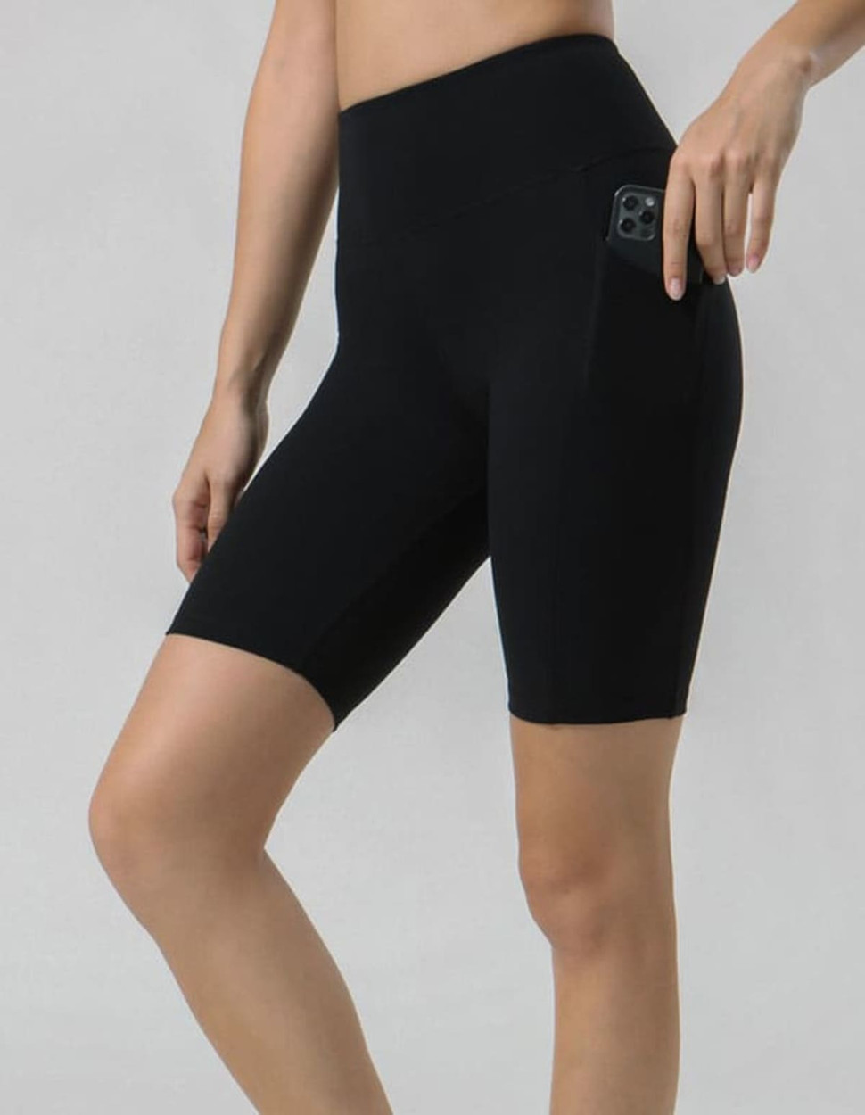 Black legging shorts featuring a side pocket, designed for comfort and style.